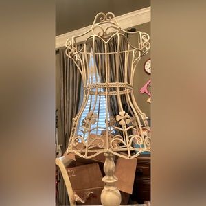 Small dress form made of metal. for decorative purposes or to display clothing.